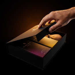 Celestial black and gold packaging detail of the Premium Gift Set · 3 Perfumes + Magic Charcoal