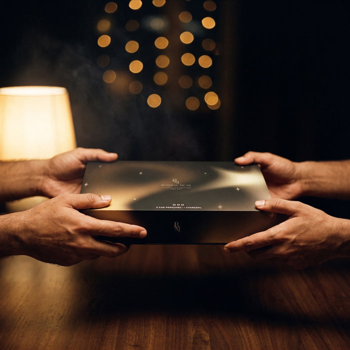 The sealed Premium Gift Set · 3 Perfumes + Magic Charcoal being handed over