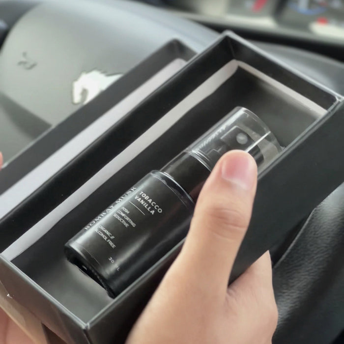 A Bombay Musk luxury car perfume seated in its tray as the box is packed by hand