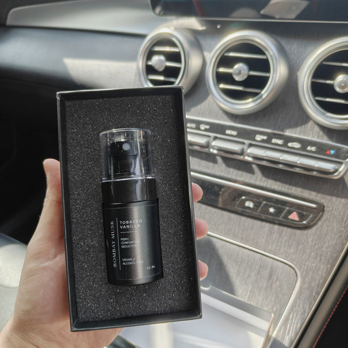 A Bombay Musk luxury car perfume seated in its tray as the box is packed by hand